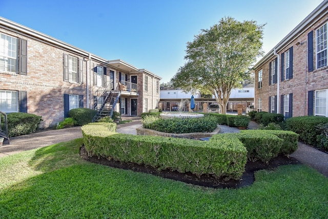 view of home's community with a lawn