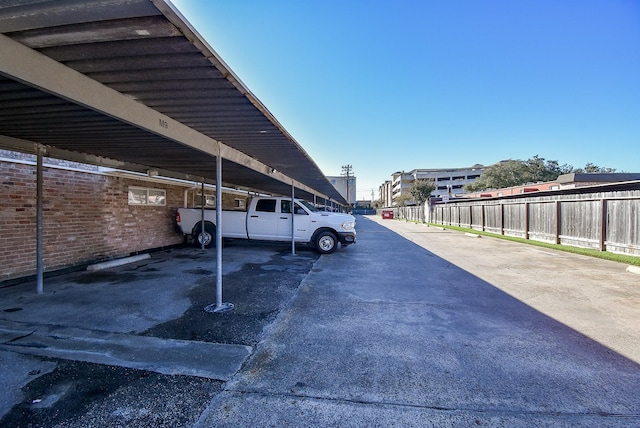 view of parking / parking lot featuring a carport