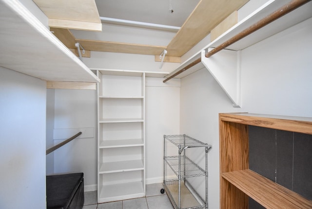 spacious closet featuring light tile patterned flooring