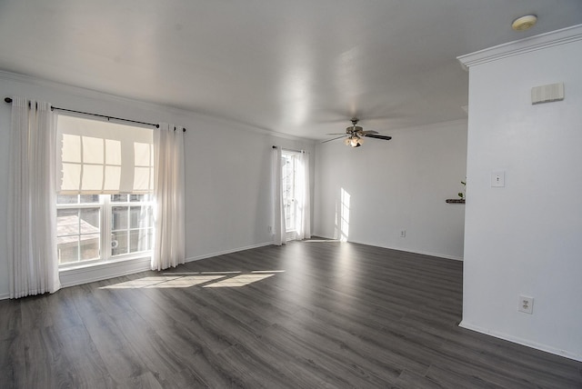 spare room with dark hardwood / wood-style flooring, ceiling fan, and crown molding