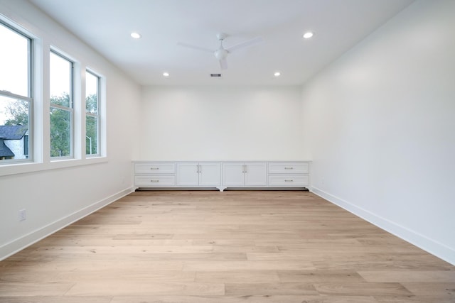 empty room featuring ceiling fan and light hardwood / wood-style floors