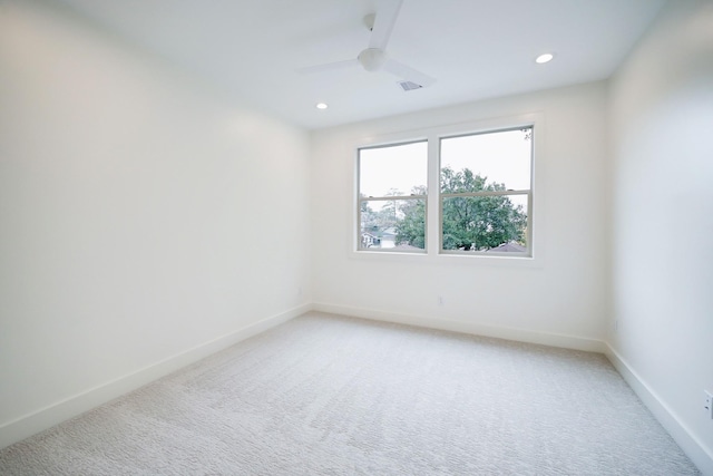 carpeted spare room with ceiling fan