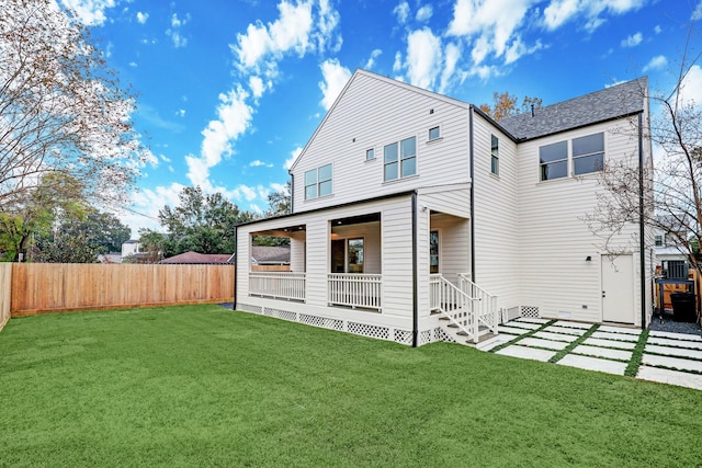 rear view of property with a yard