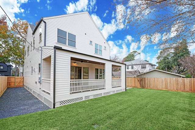 back of property featuring a lawn