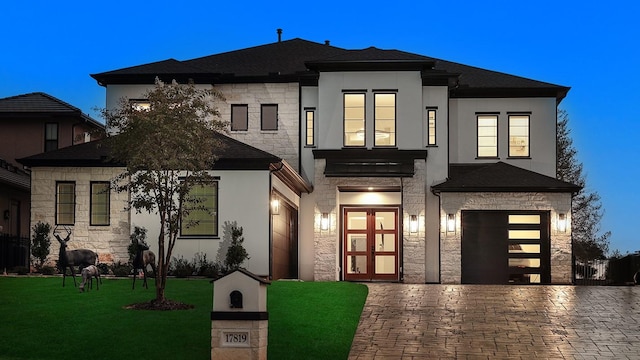 view of front facade with a front yard and a garage