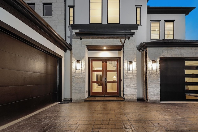 entrance to property with french doors and a garage