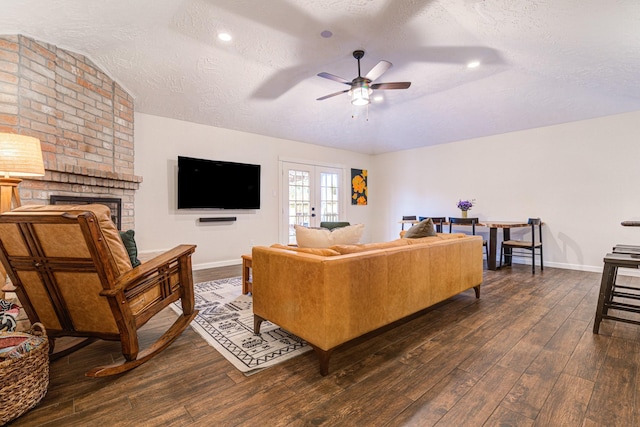 living room with dark hardwood / wood-style floors, ceiling fan, a textured ceiling, and french doors