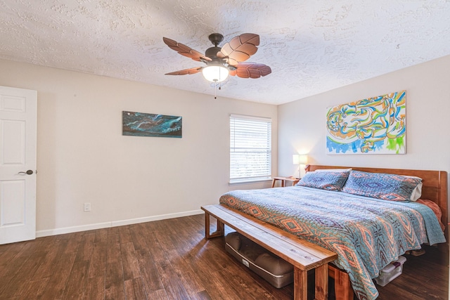 bedroom with a textured ceiling, ceiling fan, and dark wood-type flooring