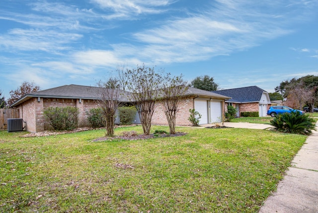 view of side of home with central air condition unit, a yard, and a garage