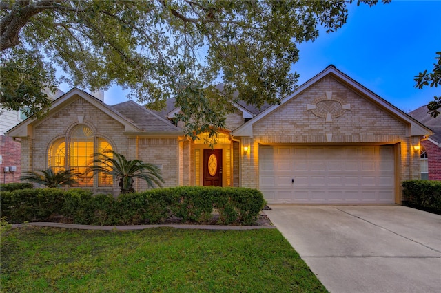 ranch-style home with a front yard and a garage