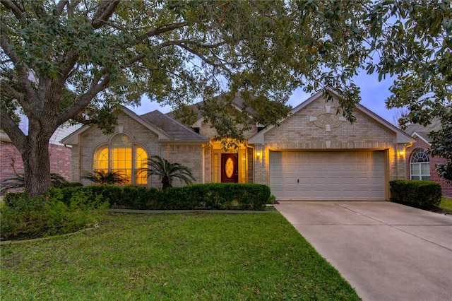 single story home featuring a garage and a front yard