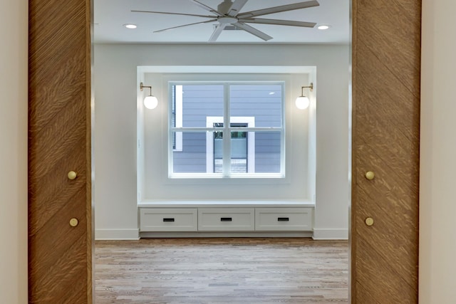 empty room with light hardwood / wood-style floors and ceiling fan