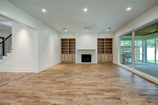 unfurnished living room with light wood-type flooring and ceiling fan