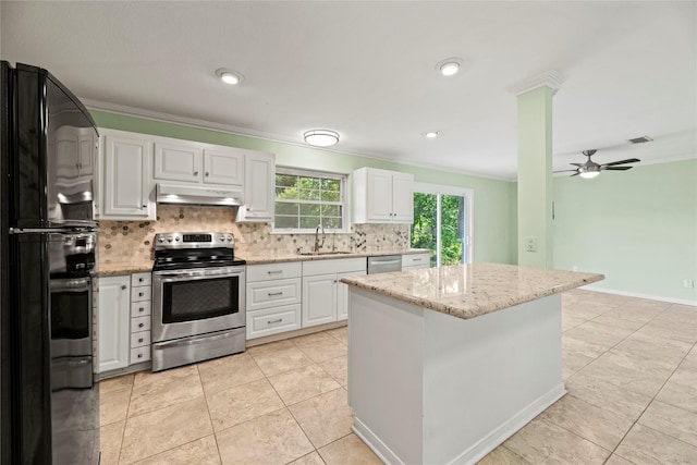 kitchen featuring appliances with stainless steel finishes, light stone counters, ceiling fan, sink, and white cabinetry