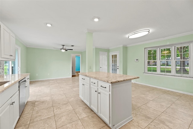 kitchen featuring dishwasher, a kitchen island, light stone counters, crown molding, and white cabinets