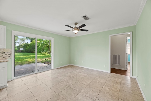 unfurnished room with ceiling fan, crown molding, and light tile patterned flooring