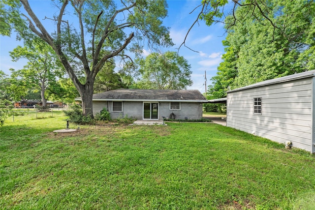 back of property featuring a yard