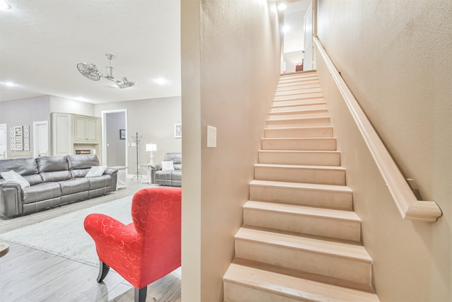 staircase with hardwood / wood-style floors