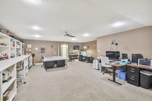 carpeted office space with ceiling fan and a textured ceiling