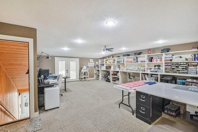 carpeted office space with ceiling fan, a textured ceiling, and french doors