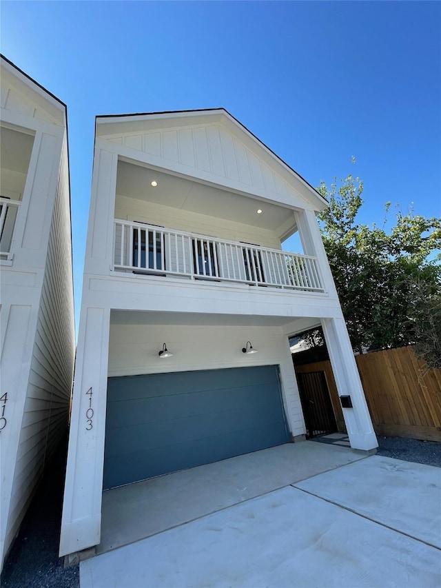 view of front of property with a balcony and a garage