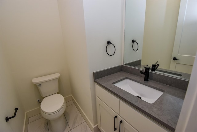 bathroom featuring tile patterned flooring, vanity, and toilet