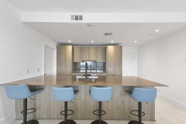 kitchen featuring kitchen peninsula and a breakfast bar