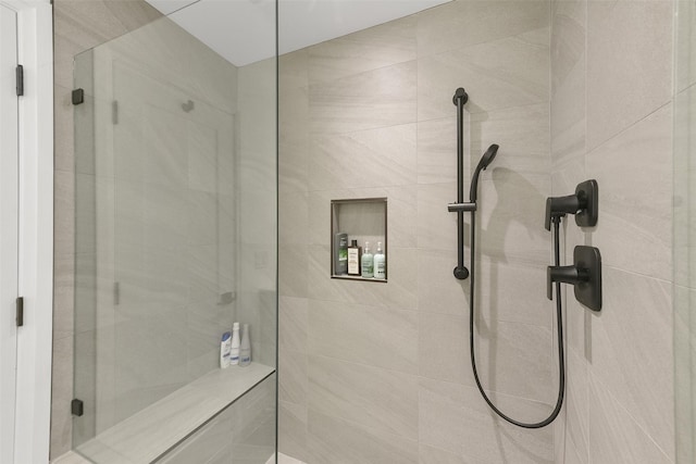 bathroom with a tile shower