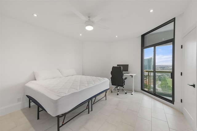 bedroom with ceiling fan and expansive windows