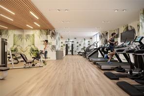 workout area featuring hardwood / wood-style floors and track lighting