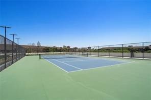 view of tennis court featuring basketball hoop