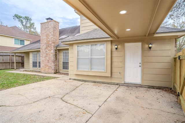 view of exterior entry featuring a patio area