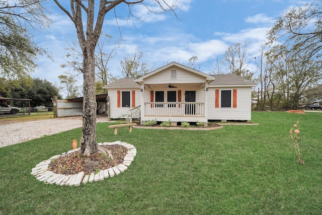 ranch-style home with a porch, a front yard, and ceiling fan