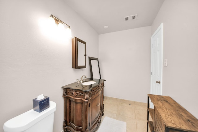 bathroom featuring vanity, tile patterned floors, and toilet