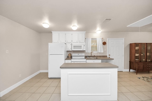 kitchen featuring light tile patterned floors, white appliances, a center island, and white cabinets