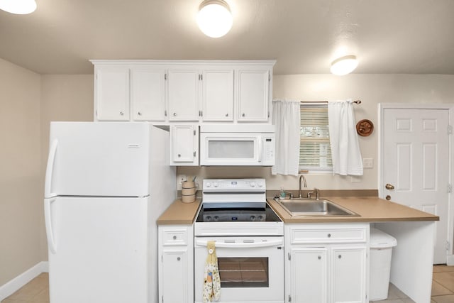 kitchen featuring white cabinetry, sink, light tile patterned floors, and white appliances