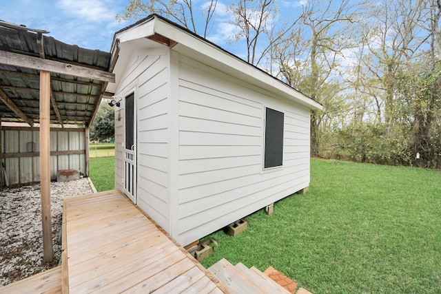 view of outbuilding featuring a yard