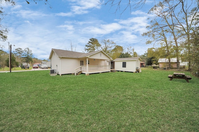 exterior space featuring a wooden deck, a yard, a storage unit, and central air condition unit