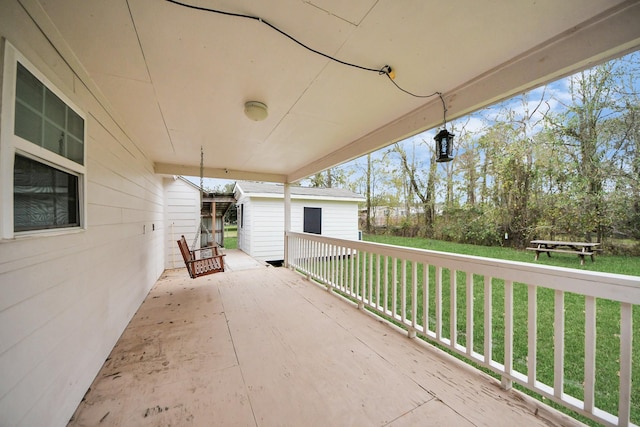 view of patio featuring a deck and a storage shed