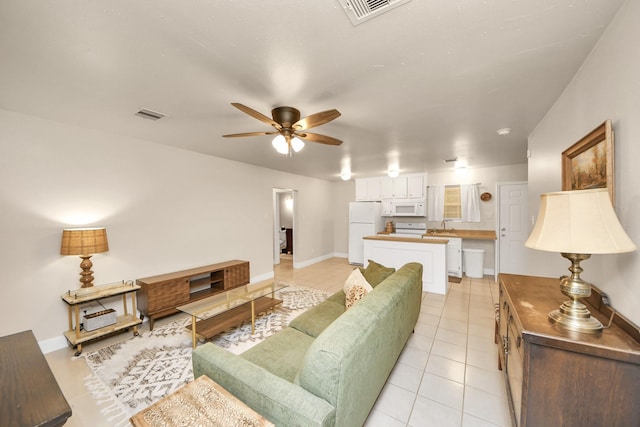 tiled living room with sink and ceiling fan