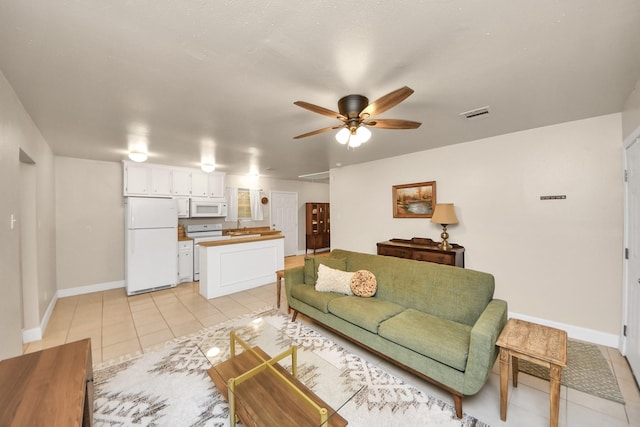 living room with light tile patterned flooring, sink, and ceiling fan