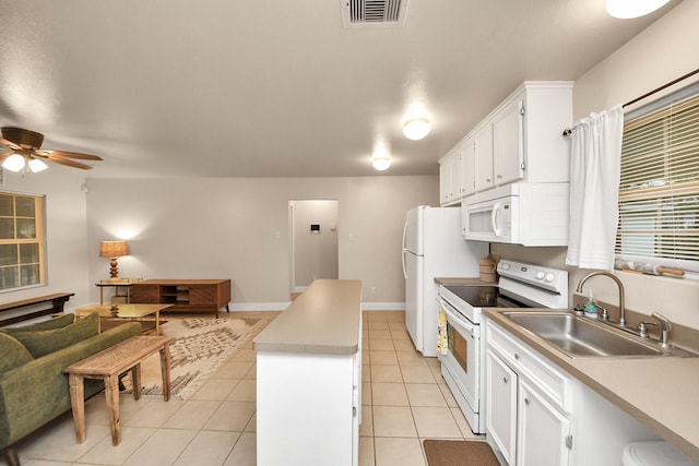 kitchen featuring white cabinetry, sink, light tile patterned floors, and white appliances