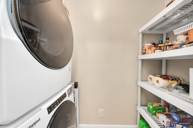 clothes washing area with stacked washer / drying machine