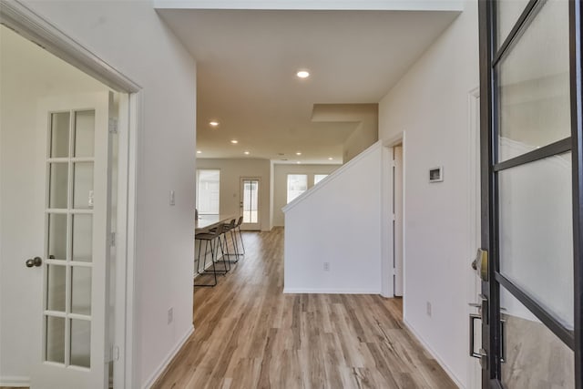 corridor with light wood-type flooring