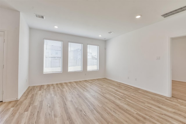 spare room featuring light hardwood / wood-style floors