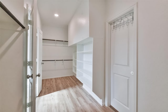 spacious closet with light hardwood / wood-style floors