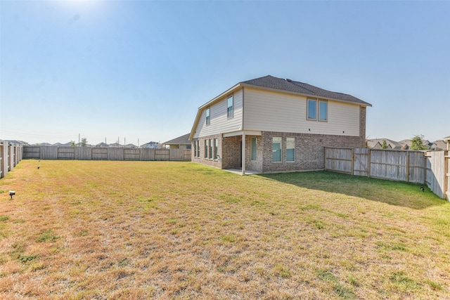 back of property featuring a lawn