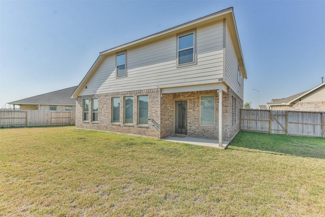 rear view of property featuring a patio area and a yard