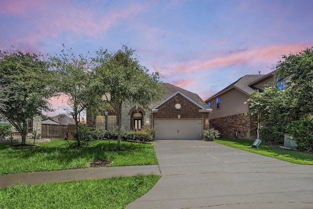 view of front facade featuring a lawn and a garage