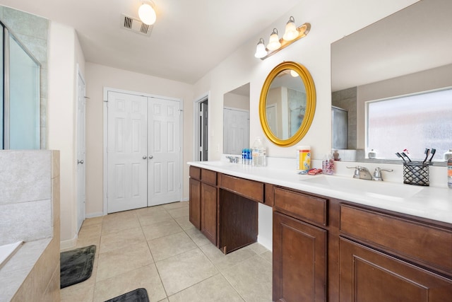 bathroom featuring tile patterned floors, vanity, and separate shower and tub